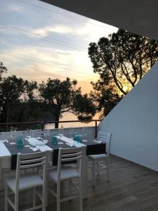 a dining table and chairs on a balcony at Villa Cataleya in Praia a Mare +29 photos