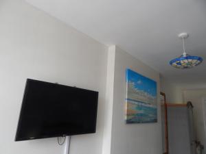 a flat screen tv hanging on a wall at The Garfield Guest House in Eastbourne