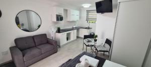a living room with a couch and a table at Marielitsa Guest Suite No 4 in Germiston