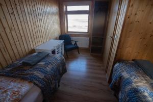 A bed or beds in a room at Fossatún Sunset Cottage