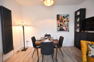 a dining room with a table and chairs at Lallan Shores in Troon