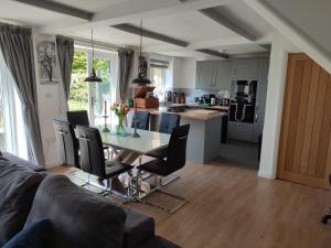 a kitchen and living room with a table and chairs at Little Fisher Farm - Farm-View Retreat in Chichester