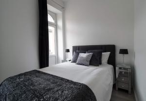 Habitación blanca con cama y ventana en EXECUTIVE DOUBLE ROOM WITH EN-SUITE CITY CENTRE IN Guest House R1 en Luxemburgo