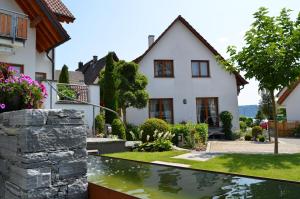 a house with a pond in front of it at OBSTHAUS Ferienwohnung Apfel in Sipplingen