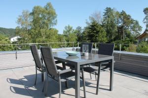 - une table et des chaises sur une terrasse avec vue dans l'établissement REBHAUS Ferienwohnung Rebdach, à Sipplingen