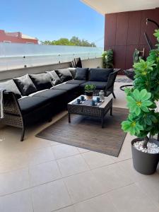 a living room with a couch and a coffee table at Beach condo Porto mós (sea view) in Lagos +29 photos