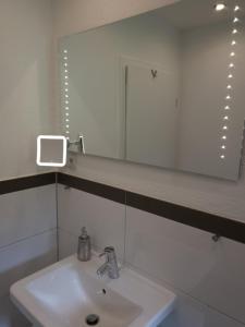 a bathroom with a sink and a mirror at Ferienwohnung Saturn in Mülheim an der Ruhr +13 photos