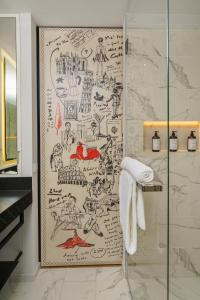 a bathroom with a shower with a map ofediautics at Andaz Vienna Am Belvedere - a concept by Hyatt in Vienna