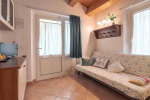 a living room with a couch and a television at Agriturismo Case al Sole in Loreto