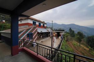 a balcony of a house with a view of a mountain at Village Homestay with Culture and Nature in Pokhara