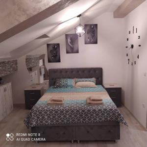 a bedroom with a large bed in a attic at Studio Apartman Dunja in Jagodina