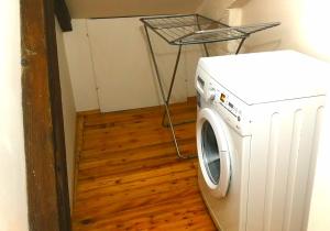 a washing machine in a room with a table at Central Loft in Tirana