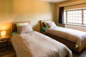 Ένα ή περισσότερα κρεβάτια σε δωμάτιο στο Le Lignely