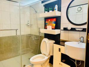 a bathroom with a toilet and a sink and a shower at Huge Loft Type Condo At Queen City of the South in Cebu City
