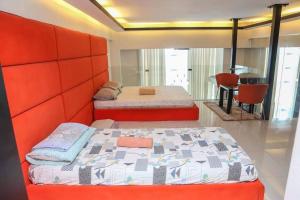 a bedroom with two beds in a room at Huge Loft Type Condo At Queen City of the South in Cebu City