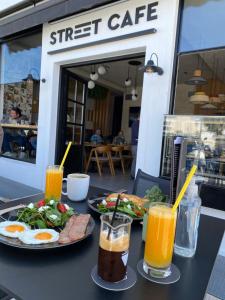 a table with two plates of food and drinks at Naxos Evilion Luxury Apartments & Suites in Naxos Chora