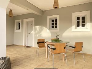 a dining room with a table and chairs at Villa Clelia in Vasilikos +64 photos