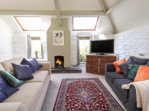 a living room with two couches and a fireplace at The Coach House in Llangollen