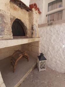a building with a door and a lantern on the ground at Merlara Otel Alaçatı in Alaçatı