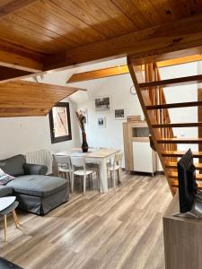 a living room with a table and a couch at Casa Lita in Panticosa