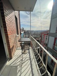 a balcony with a table and chair on a building at Taksim Rain Suite in Istanbul