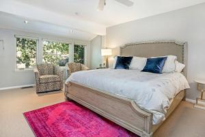a bedroom with a large bed and a pink rug at Villa's of Aspen by Snowmass Vacations in Aspen
