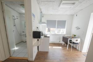 a kitchen and dining room with a sink and a table at Grindsted - Billund Apartment 1 in Grindsted