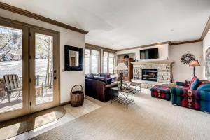 a living room with a couch and a fireplace at 202 Highlands Slopeside in Beaver Creek