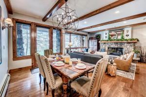 a dining room with a table and a fireplace at 205 Bear Paw Lodge in Avon