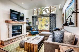 a living room with a couch and a fireplace at 306 Aspenwood Lodge in Edwards