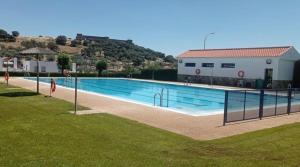 a large swimming pool in front of a building at Alojamiento EL BUTAKA in Cala