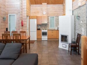 eine Küche und ein Esszimmer mit einem Tisch und einem Kamin in der Unterkunft Holiday Home Amero purnu 1 in Kolinkylä
