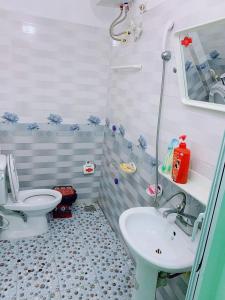a bathroom with a toilet and a sink at Minh Huy Hotel in Quang Ninh