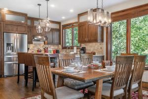 a kitchen with a wooden table and chairs at A6 Village Townhouse in Edwards