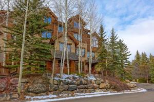 a large house in the woods with snow on the ground at A6 Village Townhouse in Edwards