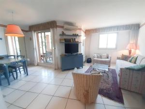 a living room with a couch and a table at Aquarella in Théoule-sur-Mer