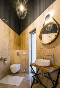 a bathroom with a sink and a mirror at EPL Luxury in Eplény
