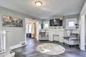 a living room with two chairs and a fireplace at Dog-Friendly Home about 14 Mi to Highmark Stadium in Cheektowaga