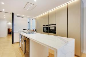 a kitchen with white countertops and a large island at Stunning apartment with view at the very heart of Paris in Paris