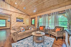 a living room with a couch and two chairs and a table at Setting Sun Cabin with Private River Access in Eagletown