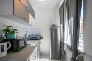 a kitchen with a stainless steel refrigerator and a window at 04 Gdynia Centrum - Apartament Mieszkanie dla 4 os in Gdynia