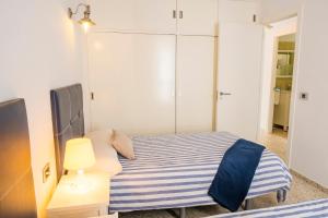 A bed or beds in a room at LIVE TAJAO BEACH
