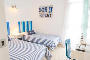 A bed or beds in a room at LIVE TAJAO BEACH