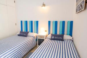 A bed or beds in a room at LIVE TAJAO BEACH