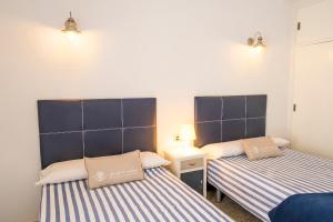 A bed or beds in a room at LIVE TAJAO BEACH