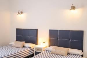 A bed or beds in a room at LIVE TAJAO BEACH