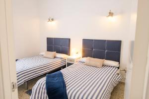 A bed or beds in a room at LIVE TAJAO BEACH