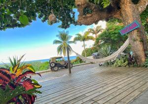 a hammock hanging from a tree on a boardwalk at Anacã Pousada in Arraial d'Ajuda