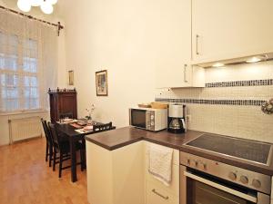 a kitchen with a table and a stove top oven at Apartment Judenplatz in Vienna