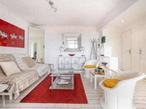 a living room with a couch and a red rug at Apartment Soleil Bleu-8 by Interhome in Canet-en-Roussillon